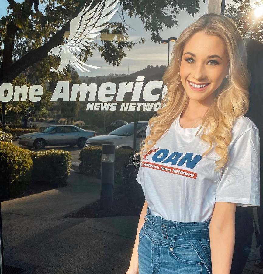 Emily in an OAN t-shirt outside the newsroom