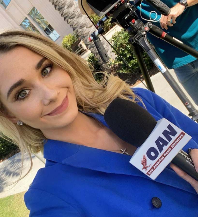 Emily anchoring on OAN, lower third reading Emily Finn