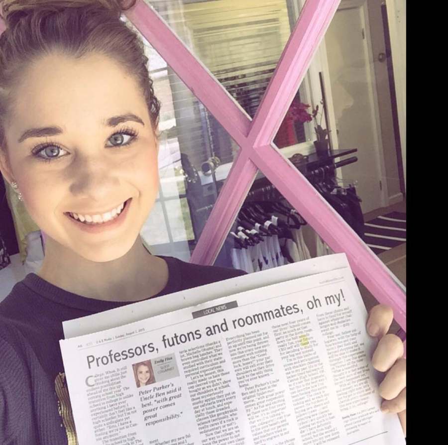 Emily holding her college newspaper column