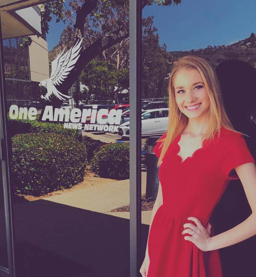 Emily outside the OAN newsroom in San Diego